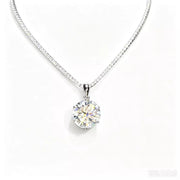 Round brilliant moissanite pendant on a silver-tone chain against a white background