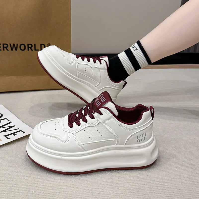 White platform sneaker with burgundy laces, side view