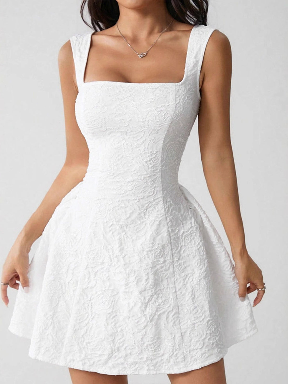 Angled front view highlighting fitted bodice and textured flared skirt