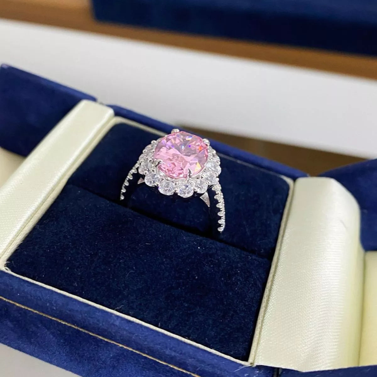 Close angled view of the pink oval stone and surrounding clear stones.