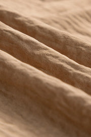 Detail of the soft woven fabric on tan utility trousers