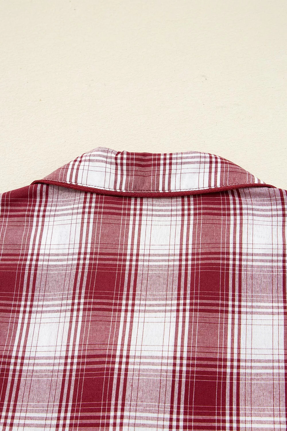 Red plaid pajama shorts shown with shirt, flat lay