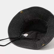 Inside of black mountain-embroidered bucket hat showing chin cord and eyelets