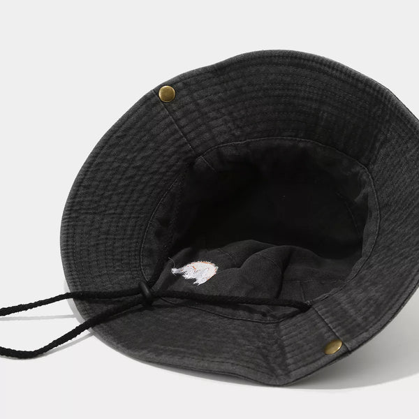 Inside of black mountain-embroidered bucket hat showing chin cord and eyelets