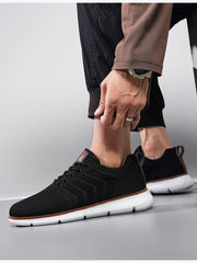 Black mesh lace-up shoes shown from the side with black trousers