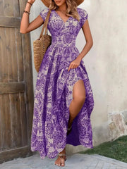 Brown floral cap-sleeve maxi dress with a thigh-high slit and gathered tiered skirt.
