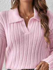 Close view of light pink ribbed sweater's polo collar and vertical knit texture