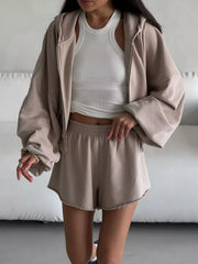 Angled view of olive hoodie and matching shorts with gathered waist