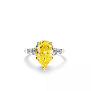Yellow pear-shaped center stone ring shown from the front.