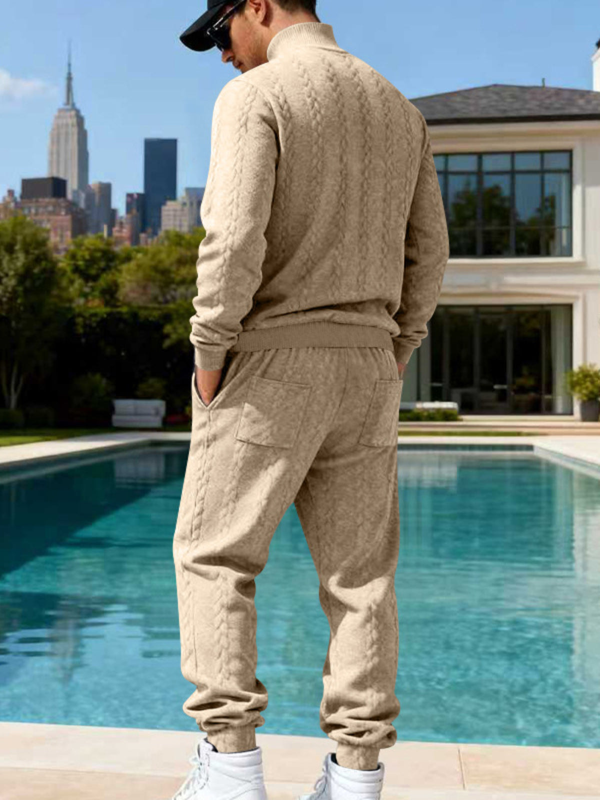 Beige cable-knit sweater and joggers shown from the back.