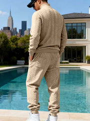 Beige cable-knit sweater and joggers shown from the back.