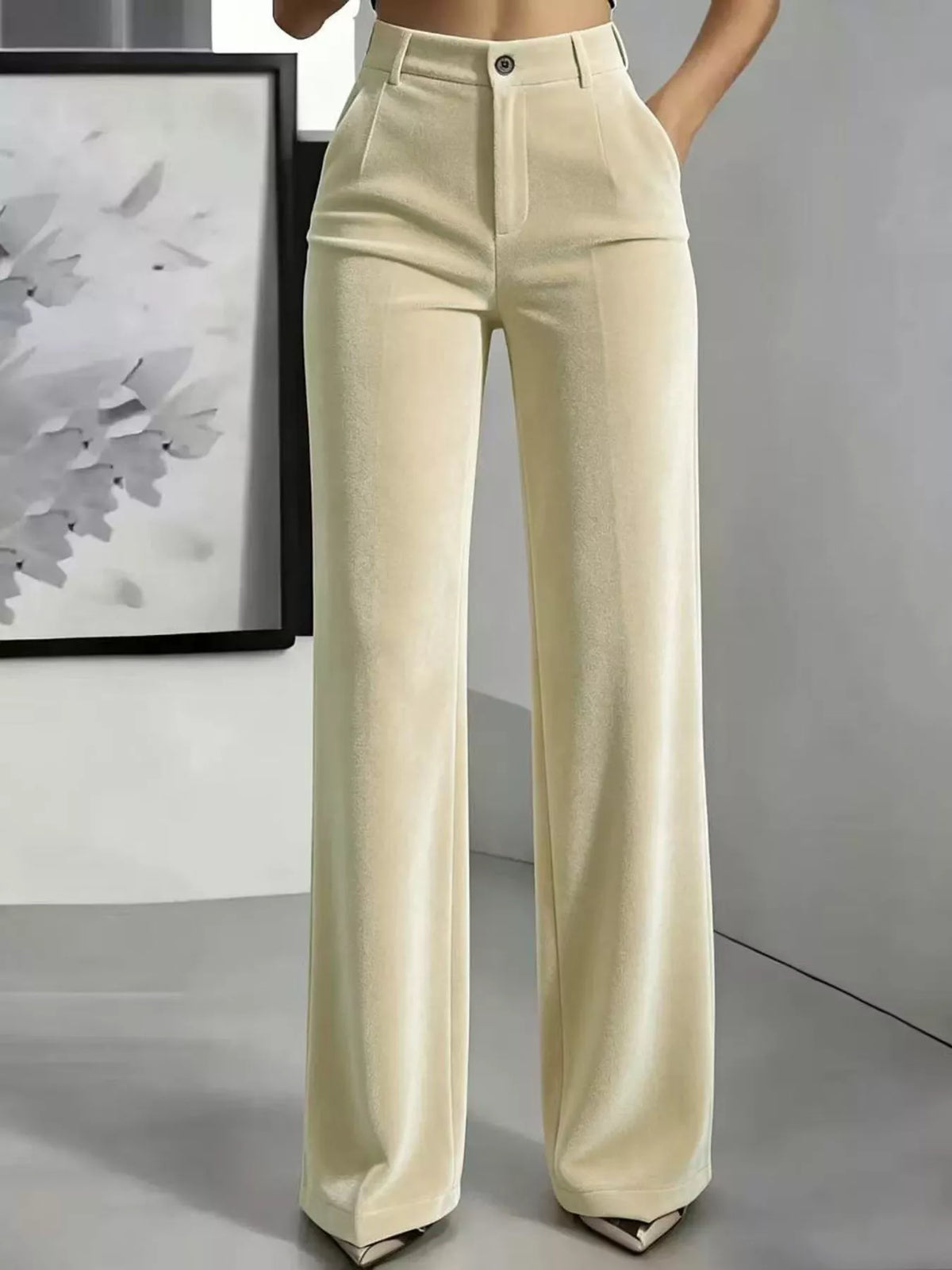 Cream high-waisted velvet trousers with wide legs, belt loops and front pockets, full front view