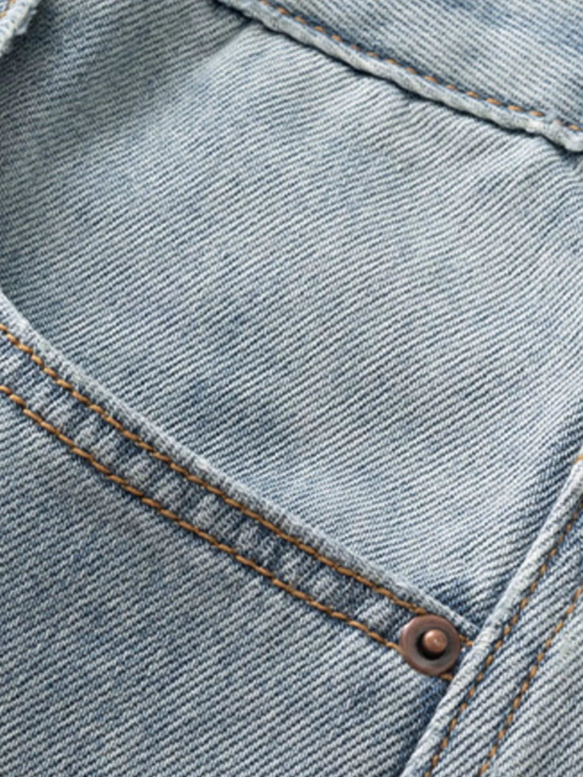 Close-up of light blue denim seam and stitching