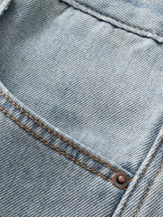 Close-up of light blue denim seam and stitching