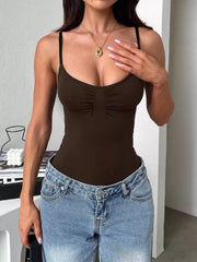 Brown scoop-neck cami front with hand at chest