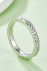 Angled view of a slim pavé band on pale green fabric.