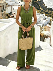 Army-green jumpsuit, front view with woven handbag