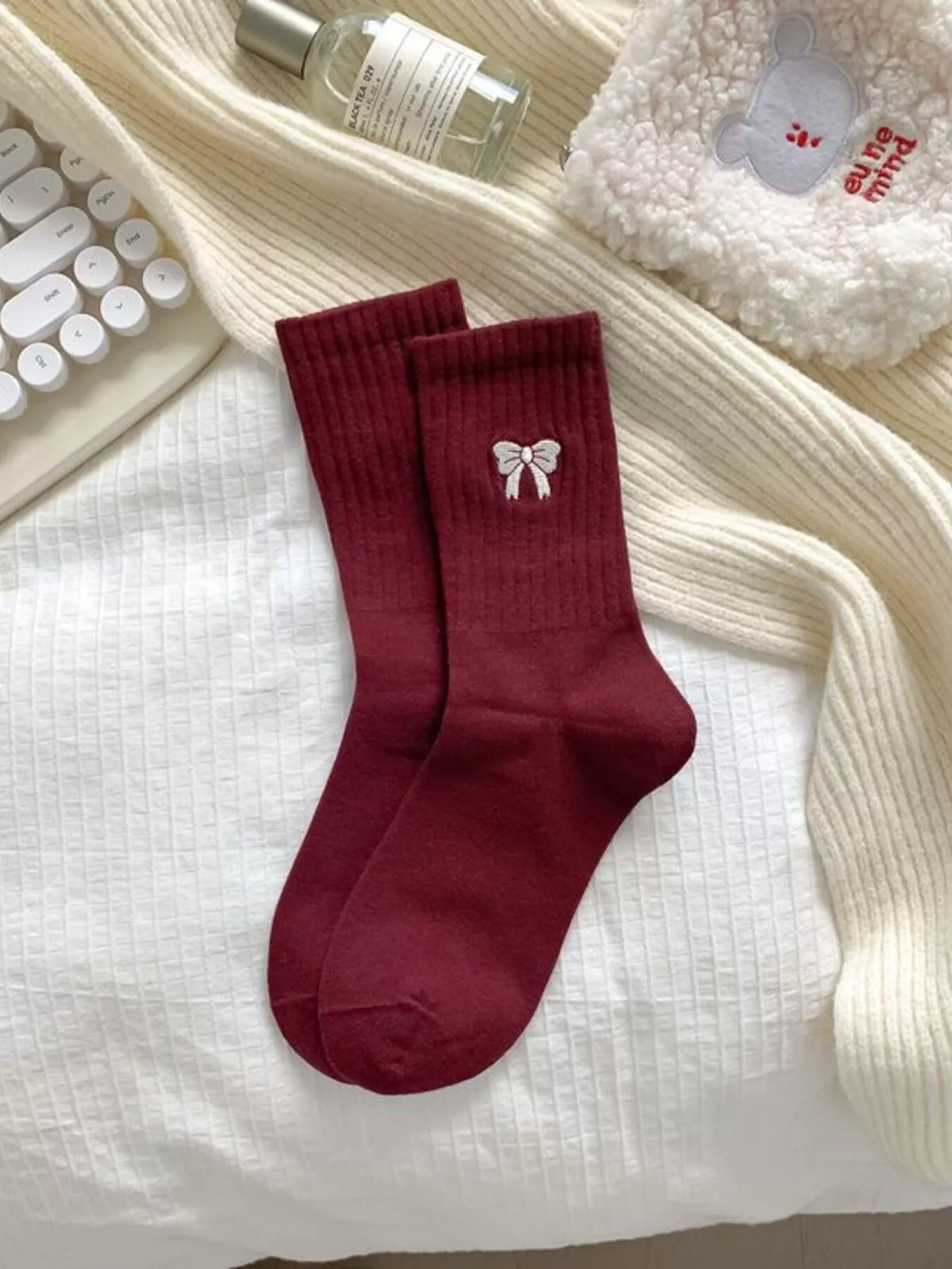 Burgundy ribbed crew socks with bow motif laid flat