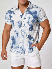 Model wearing a white shirt with blue-gray abstract print, front view