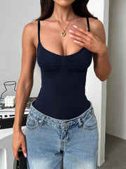 Dark navy scoop-neck cami front with blue jeans