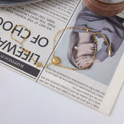 Sun charm bracelet styled with a coordinated gold necklace