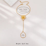Gold-tone flower hand chain bracelet with size information in image