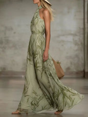 Side view of the sleeveless leaf-print maxi dress.