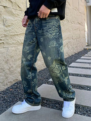 Angled front view of loose blue patterned jeans worn with white trainers