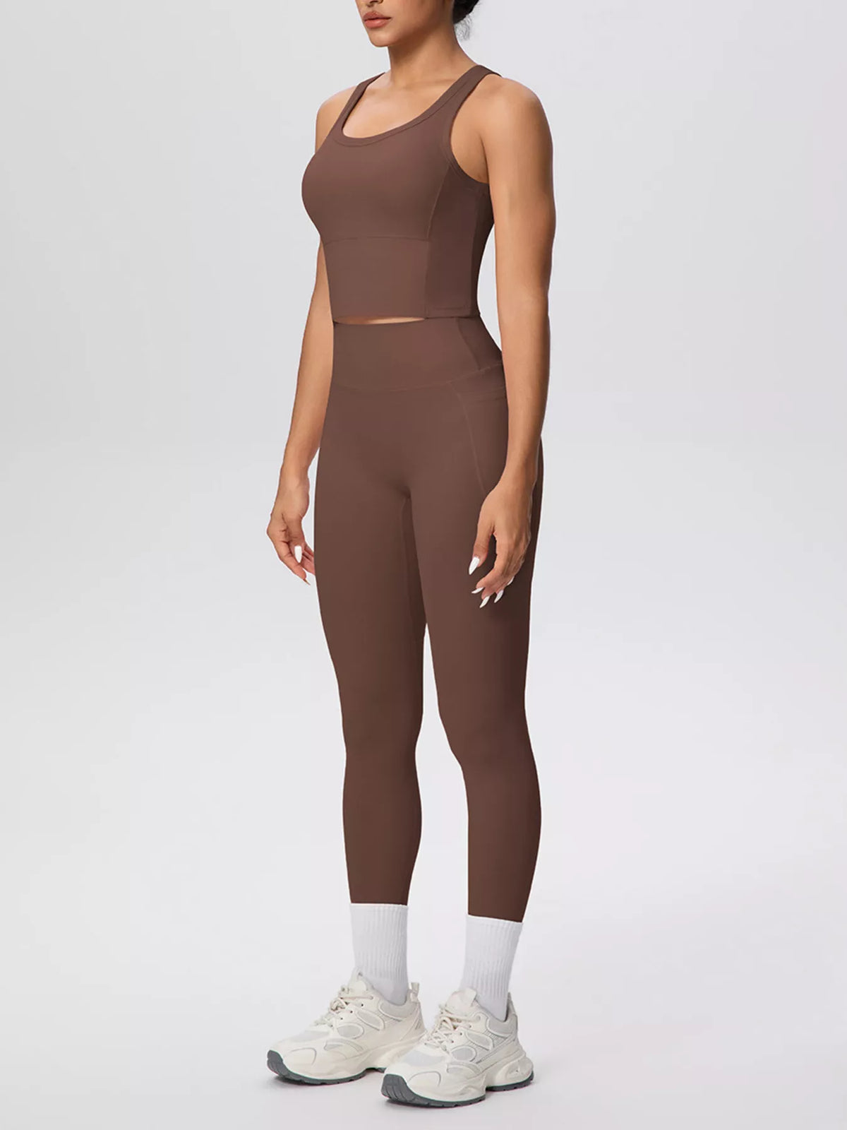 Brown activewear set shown in a side pose with one arm raised