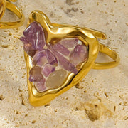 Close view of gold-plated heart-shaped ring set with pink stones