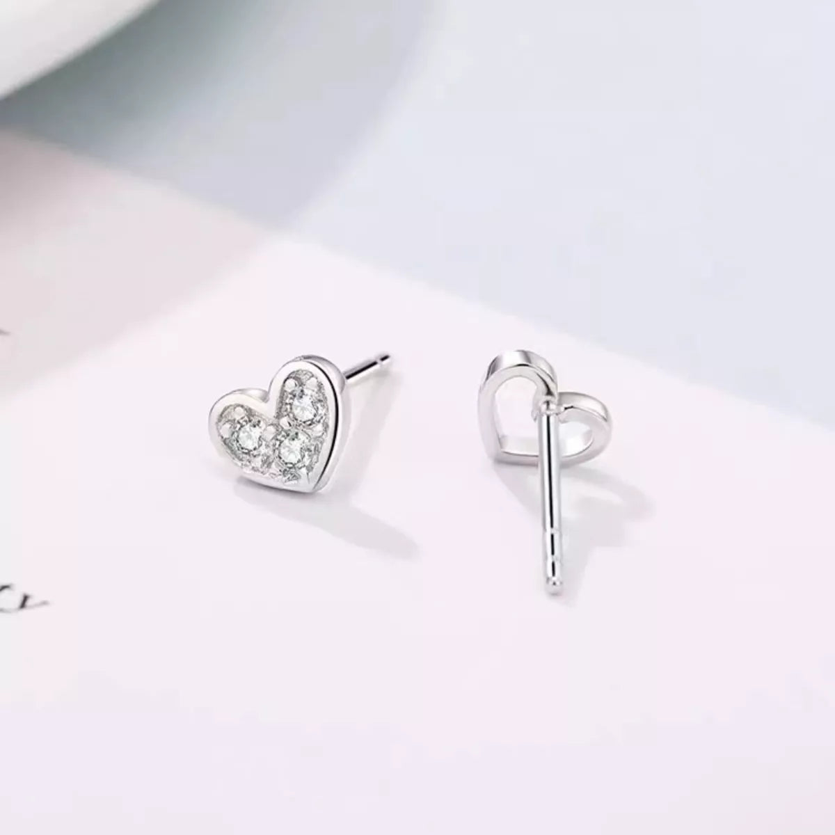 Heart stud earring and butterfly back shown from side