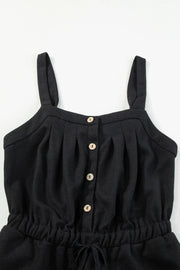 Black jumpsuit bodice showing knotted straps and button placket