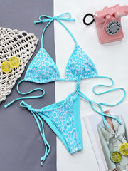 Pink-trimmed leopard halter bikini laid flat