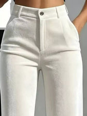 Close-up of white velvet trousers showing belt loops, button closure and front pockets