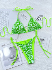 Green leopard-print halter bikini modeled close-up