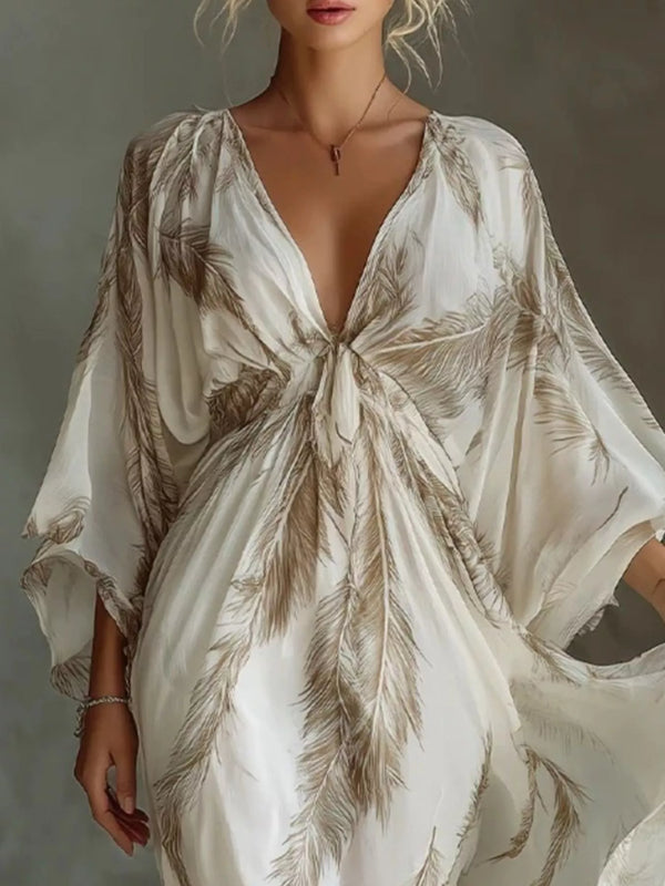 Close view of the brown feather-print maxi dress showing the tied V-neckline and loose sleeves.