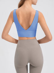 Back view of the blue cropped tank with a deep V-shaped neckline