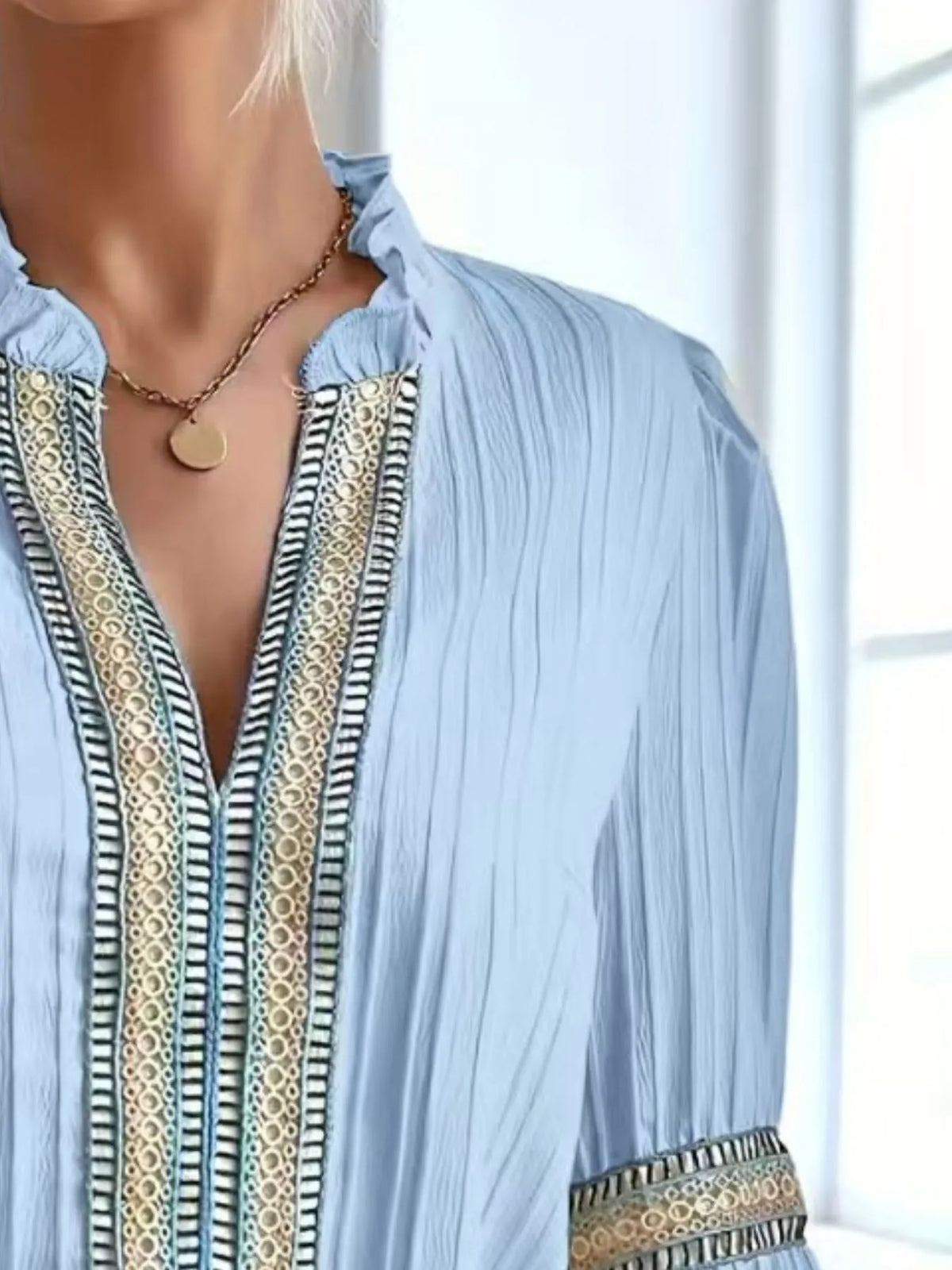Notched textured balloon-sleeve blouse in blue close front view