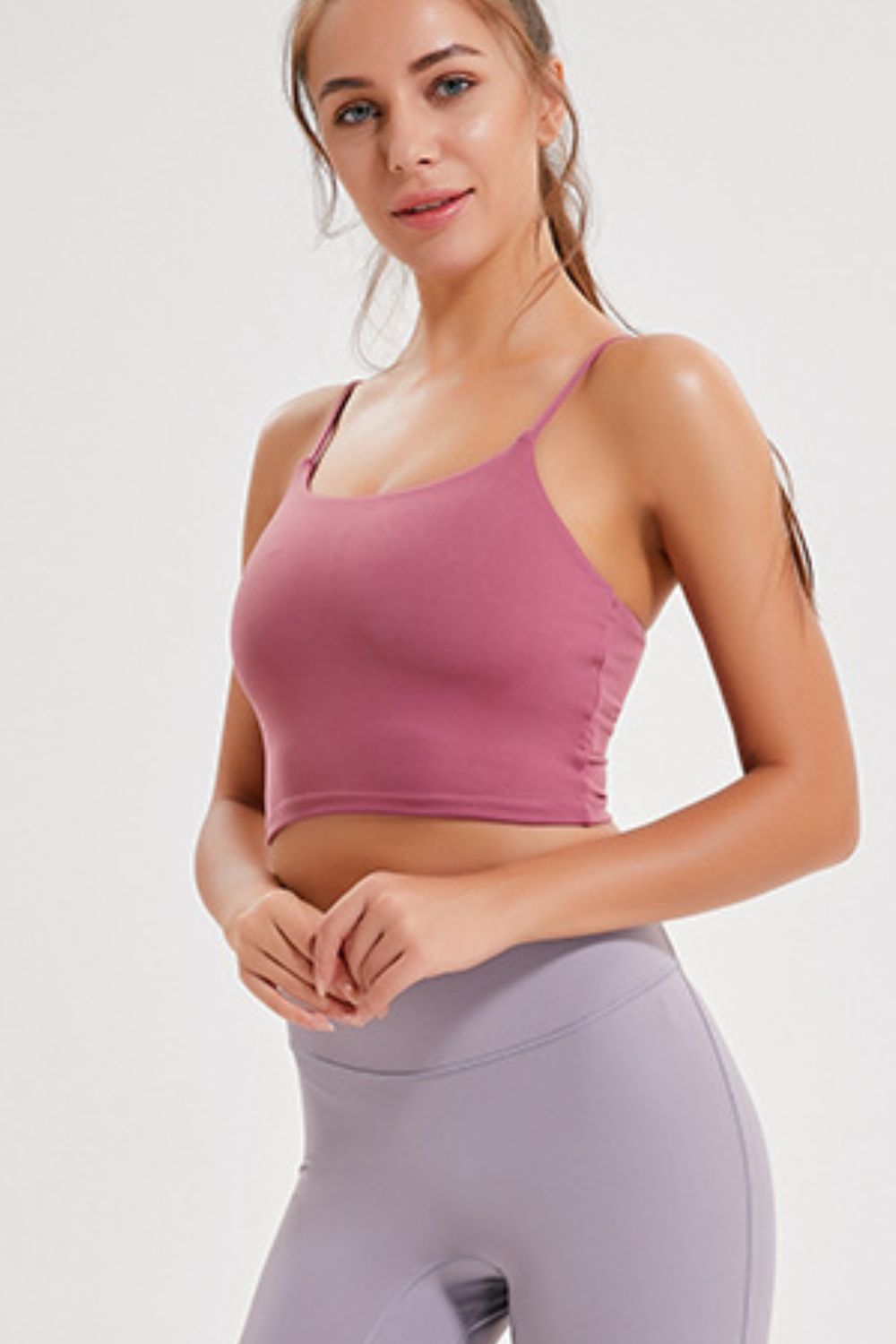 Model wearing the rose-pink cami with lilac leggings, shown from the front.