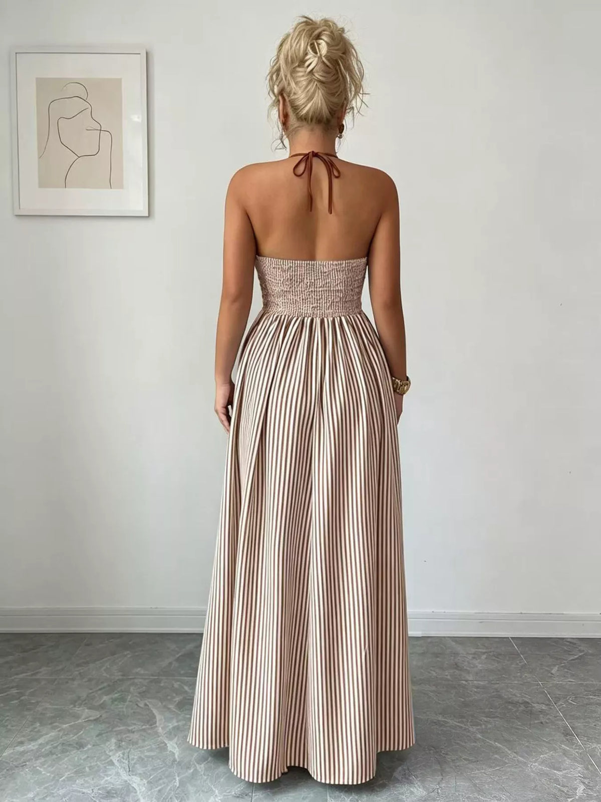 Back view of khaki halter maxi dress showing gathered waist and neck ties