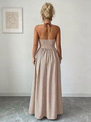 Back view of khaki halter maxi dress showing gathered waist and neck ties