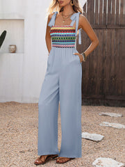 Light blue jumpsuit with colorful patterned bodice