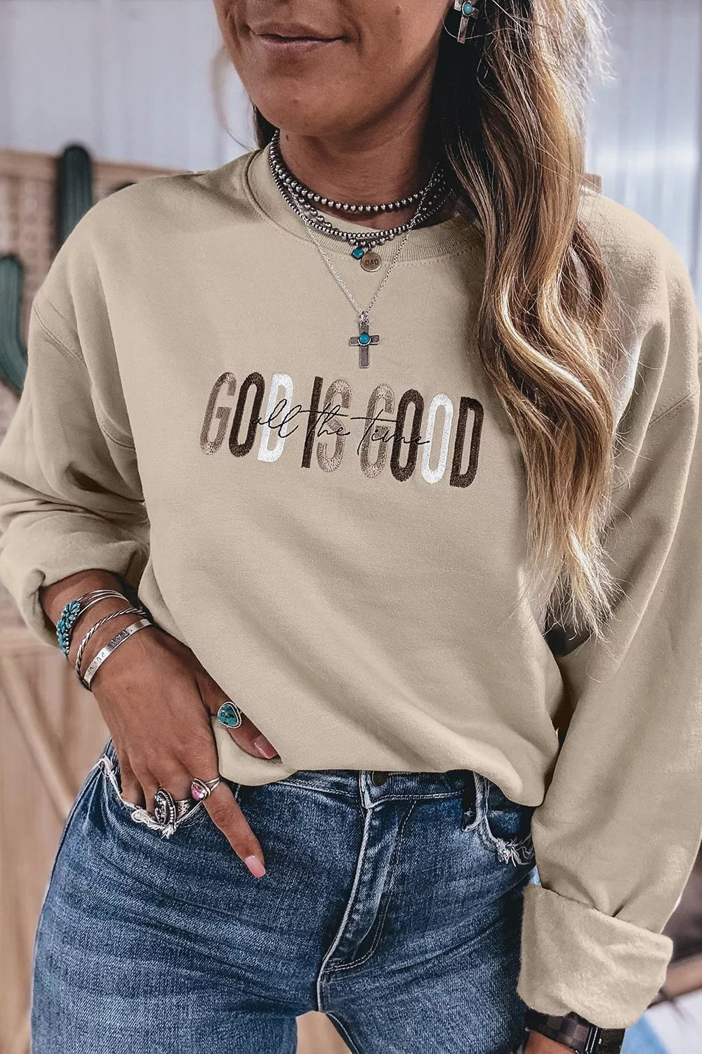 Front view of faith graphic sweatshirt with casual jeans