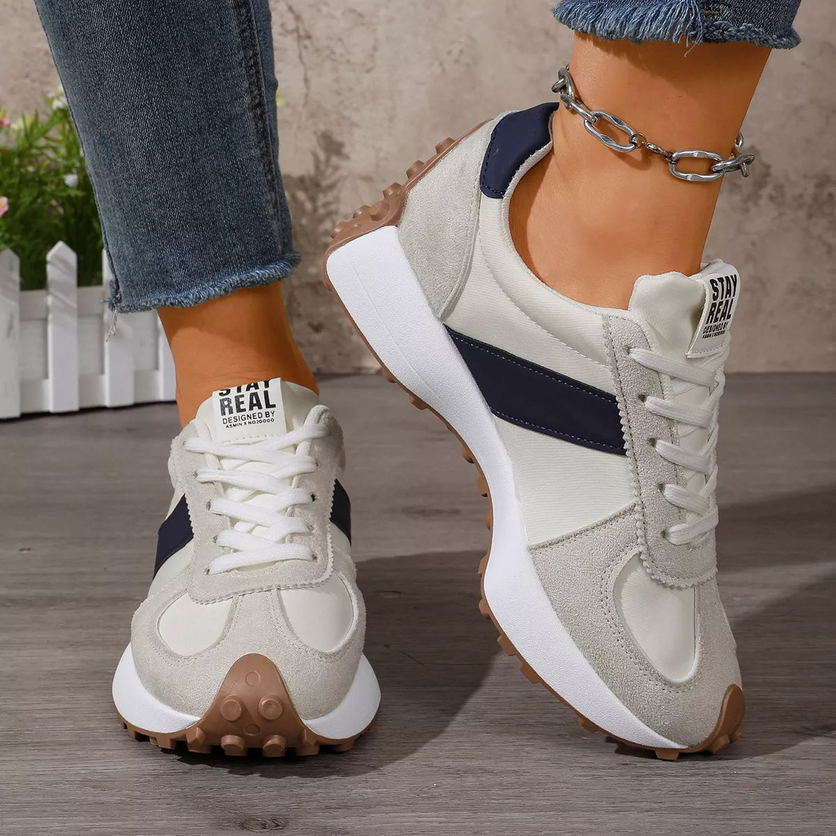 Front view of white sneakers with black side panels