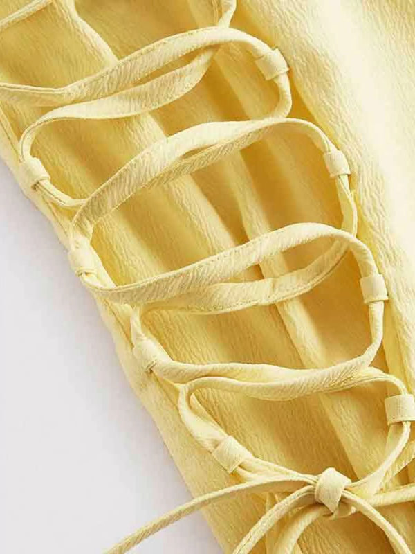 Light yellow dress showing side lace-up detail