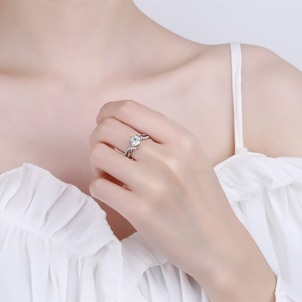 Clear stone moissanite ring worn on hand