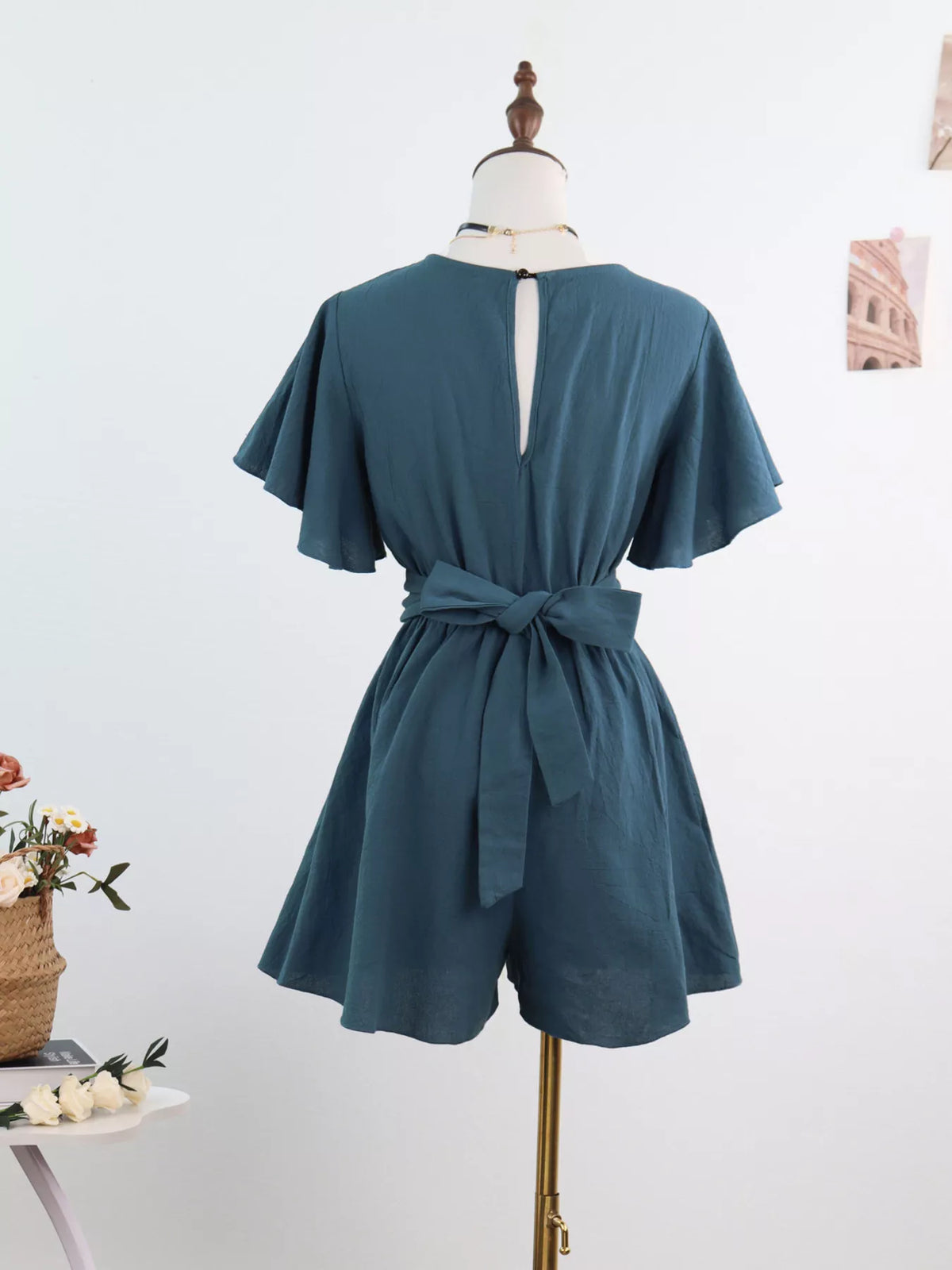 Back view of haze blue romper with tie waist