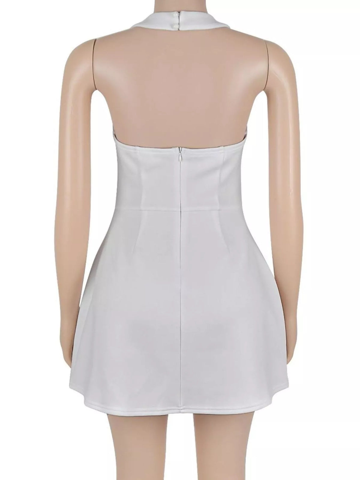 Back view of the white halter mini dress on a mannequin, showing the neck fastening and back zip.