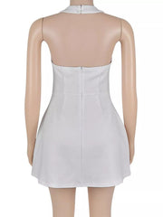 Back view of the white halter mini dress on a mannequin, showing the neck fastening and back zip.