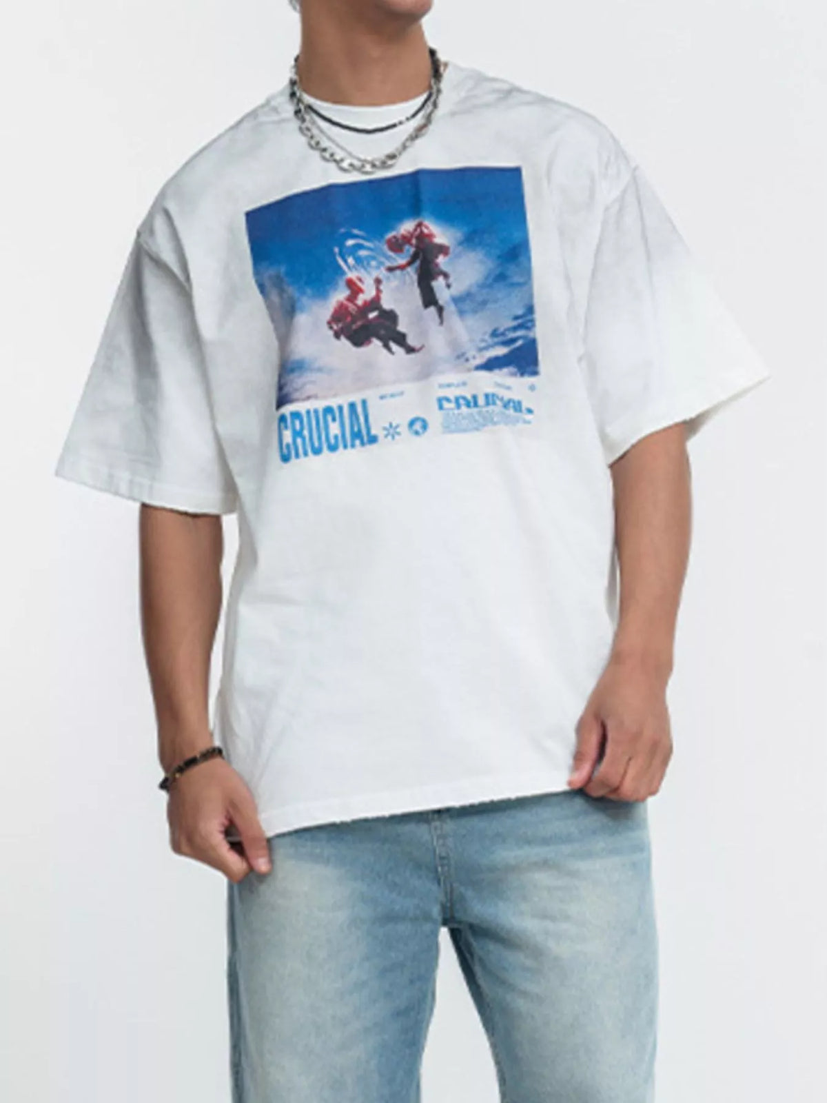Model wearing white graphic T-shirt with blue print